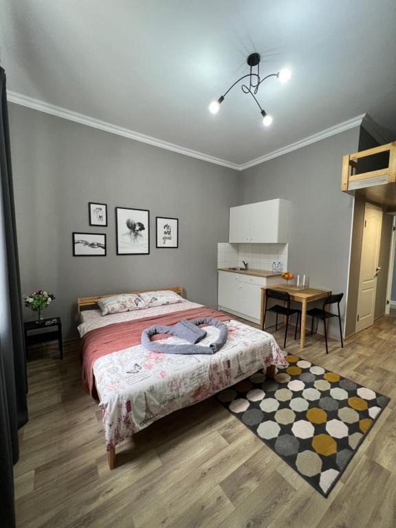 a bedroom with a bed and a table in it at Гостевой Отель-125 in Aktau