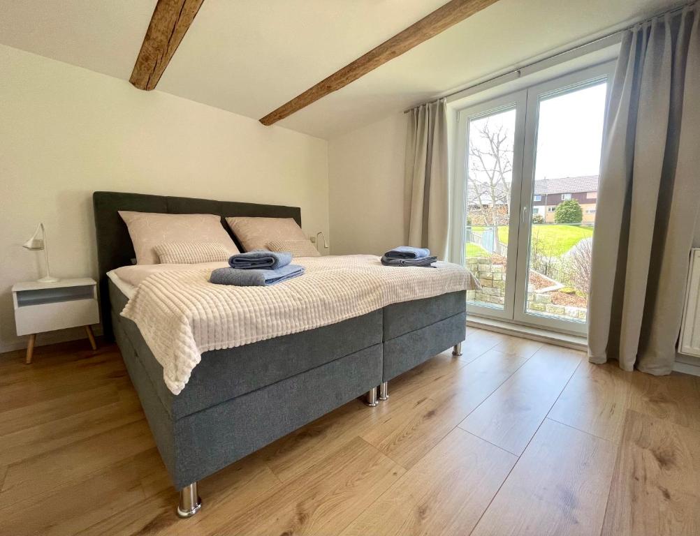 Postel nebo postele na pokoji v ubytování Ferienhaus „Am Sandstein“