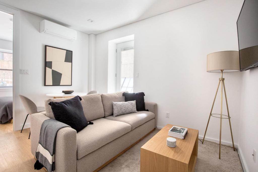 a living room with a couch and a table at SoHo 1br w outdoor space in-unit wd NYC-1142 in New York
