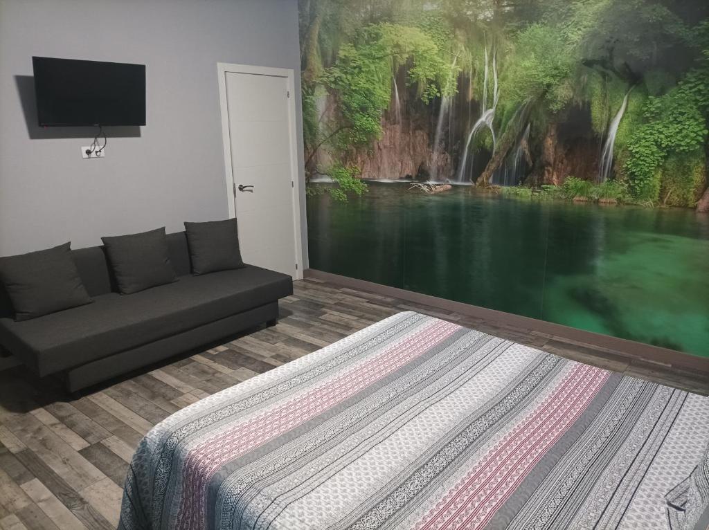 una sala de estar con sofá y una pintura en la pared en Hostal El Bosque Encantado Toledo, en Toledo