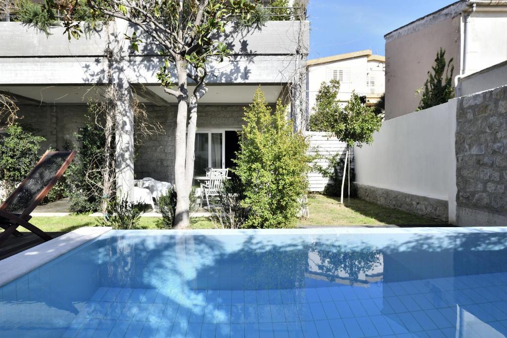 a swimming pool in the backyard of a house at Loft Favoloso con piscina in Tortolì
