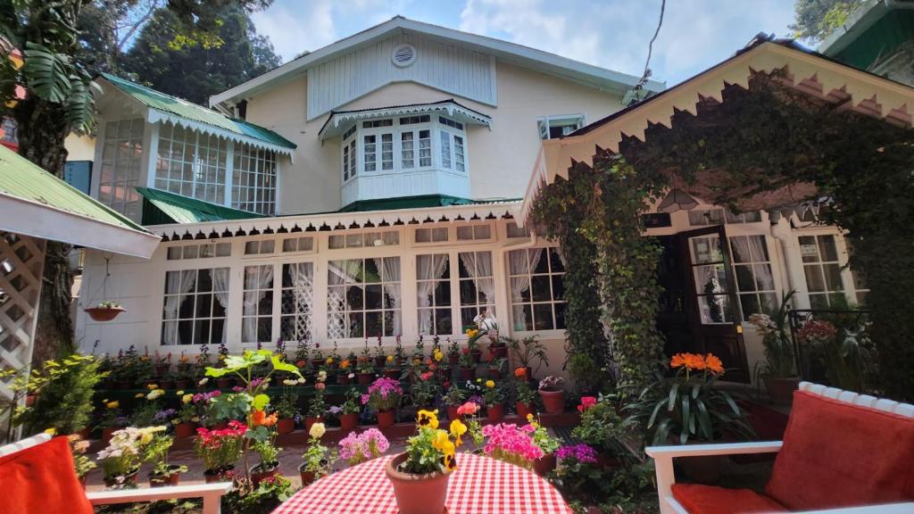 a house with flowers in front of it at Ivanhoe Hotel (A Heritage Property) in Darjeeling