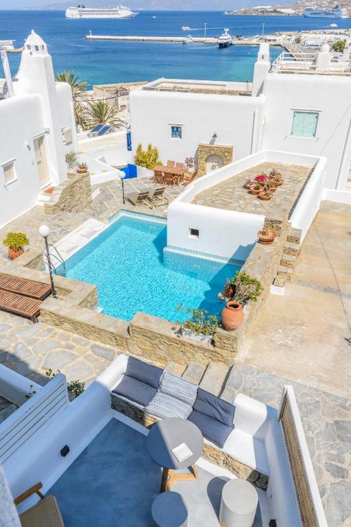 a villa with a swimming pool and a view of the ocean at Mykonos Perla Town House in Mikonos