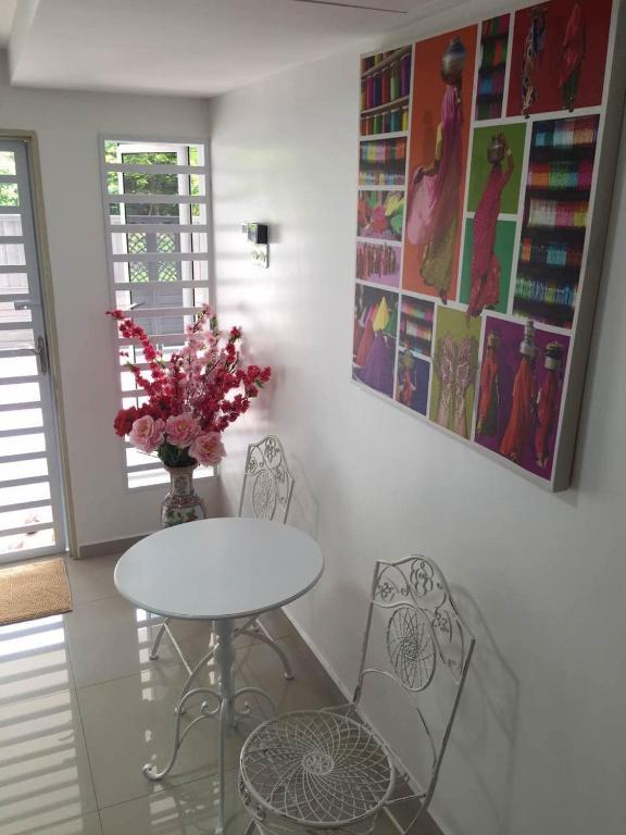 a dining room with a table and two chairs at Lavender house IPOH in Ipoh