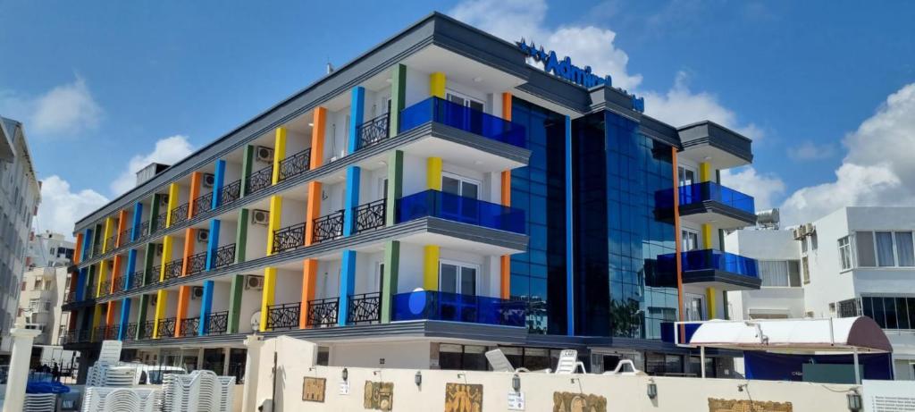 a building with colorful balconies on a city street at Admiral Hotel in Kizkalesi