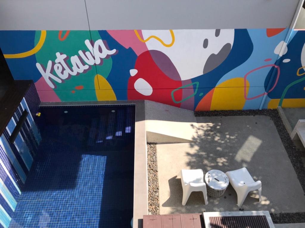 an overhead view of a building with a mural at Ketawa Pet Friendly Hotel in Chiang Mai