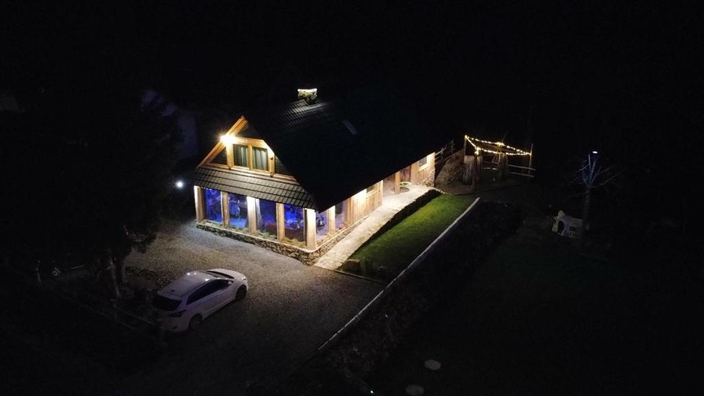 a house with a car parked in front of it at night at Wioska Kowala in Tyrawa Wołoska