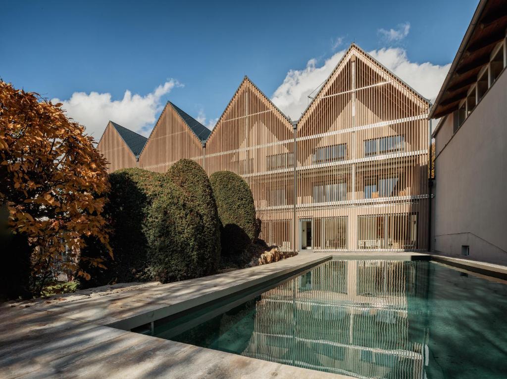- un bâtiment avec une piscine en face dans l'établissement Romantik Hotel Hirschen, à Parsberg