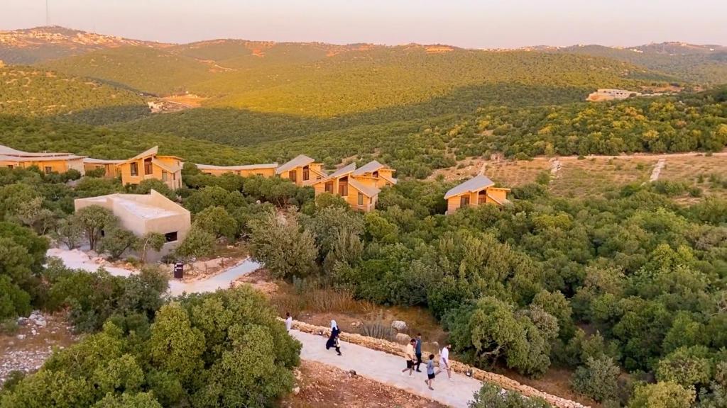 a group of people walking down a path in a forest at Ajloun Forest Reserve in Jerash