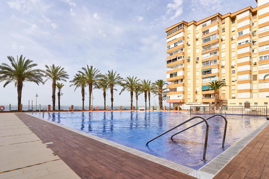 a swimming pool with a slide in front of a building at Estudio Fetén Algarrobo Costa in Algarrobo-Costa