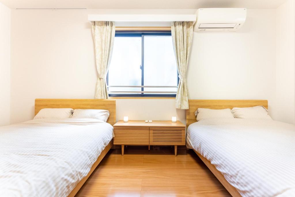 Postel nebo postele na pokoji v ubytování Minami-Aoyama-1st