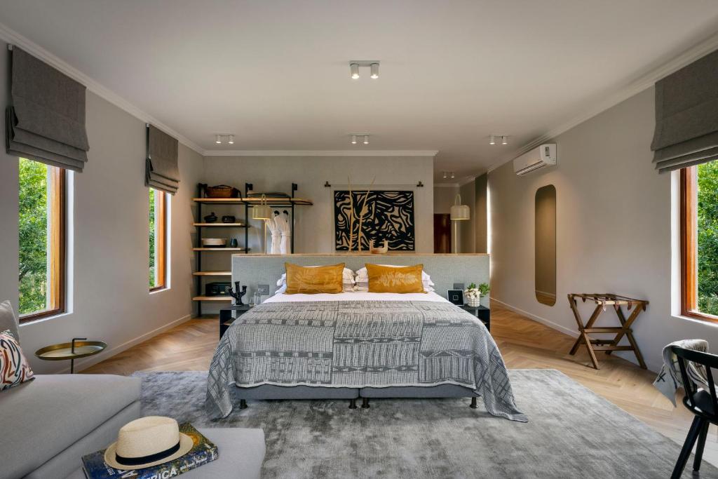 a bedroom with a bed with orange pillows in it at The Peech Hotel in Johannesburg