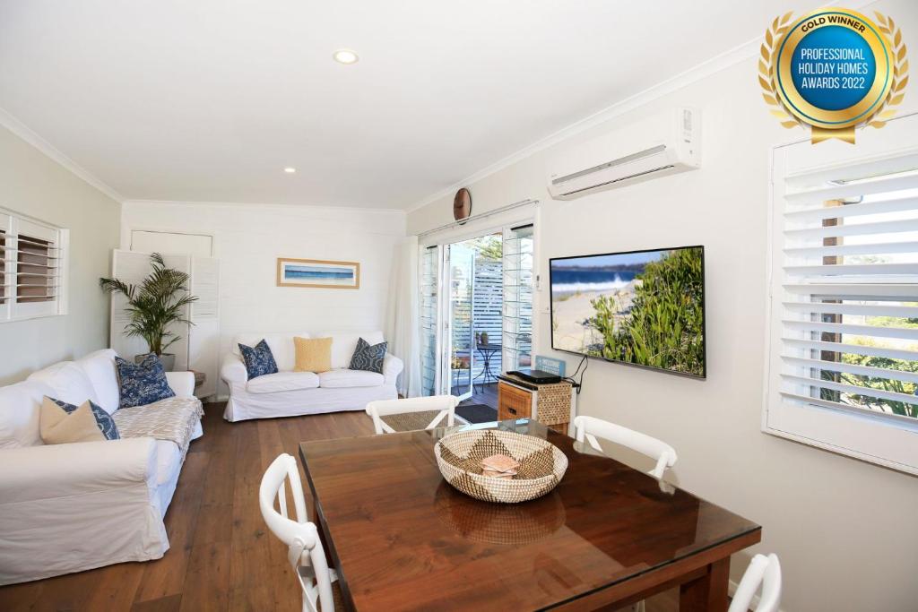 a living room with a table and a couch at Jervis Bay Beach Shack I Pet Friendly in Vincentia
