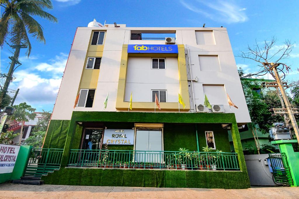 a building with a sign on the side of it at FabHotel Royal Crystal in Bhubaneshwar