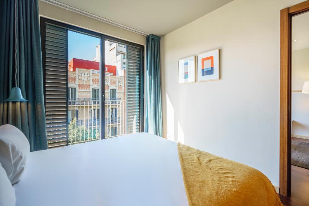 Posteľ alebo postele v izbe v ubytovaní Aspasios Diagonal Art Apartments