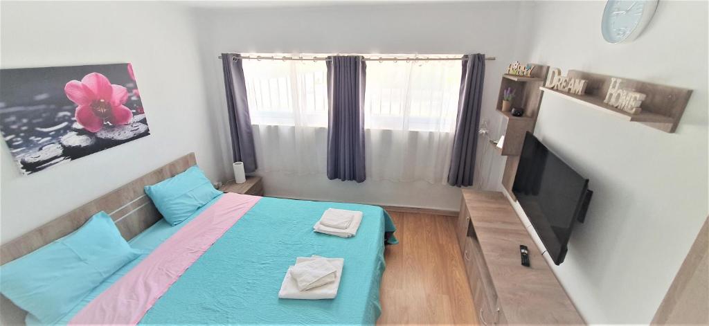 Il comprend une petite chambre avec un lit et une télévision à écran plat. dans l'établissement VACATION STUDIO OROPOS, à Néa Palátia