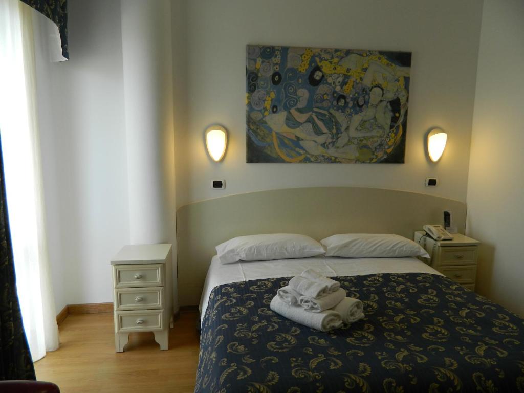 Łóżko lub łóżka w pokoju w obiekcie Hotel La Palazzina