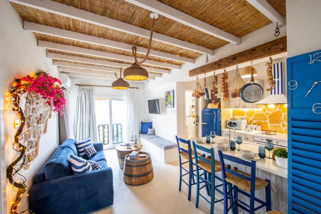 a kitchen and living room with blue chairs and a blue couch at Castle Holiday Apartments in Limassol