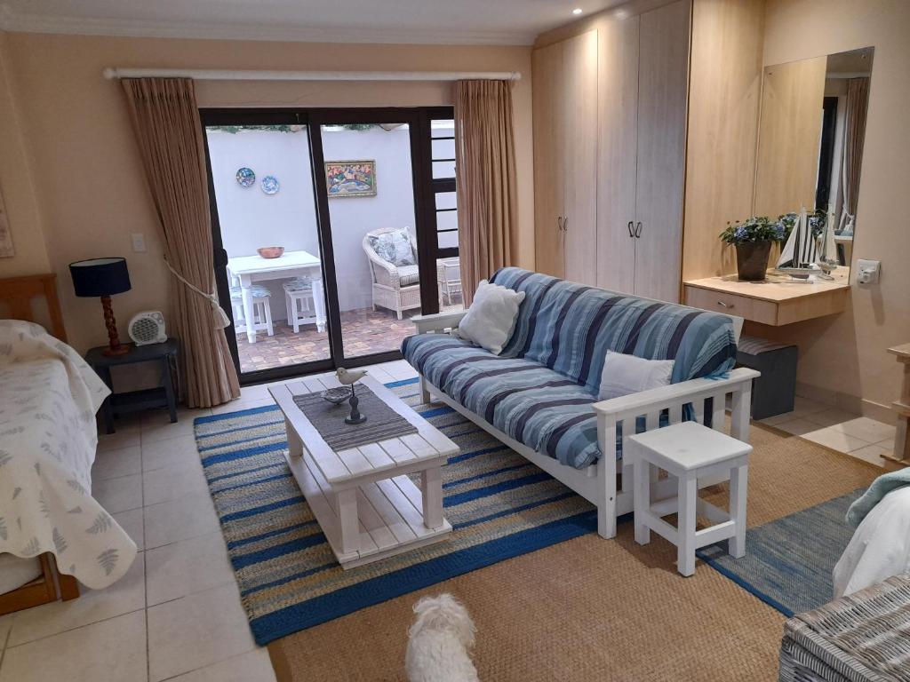 a living room with a couch and a table at Barnard Self-Catering Apartments in St Francis Bay