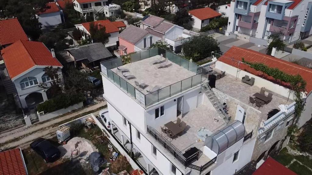 an overhead view of a white building in a city at Music Vir Apartment in Vir