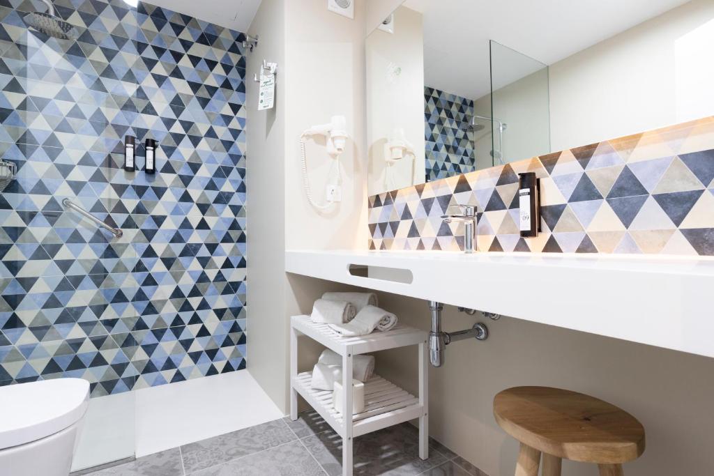 a bathroom with a sink and a mirror at Esmeralda Cotillo Homes by LIVVO in El Cotillo