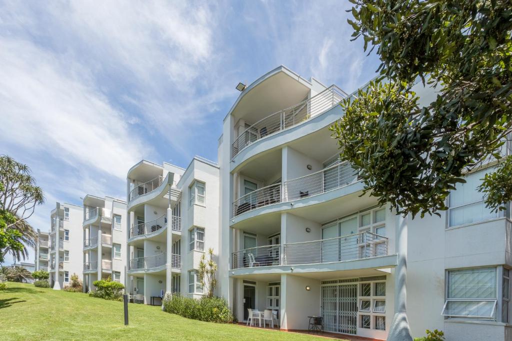 an image of an apartment building with a lawn at Chaka's Cove 66 in Ballito