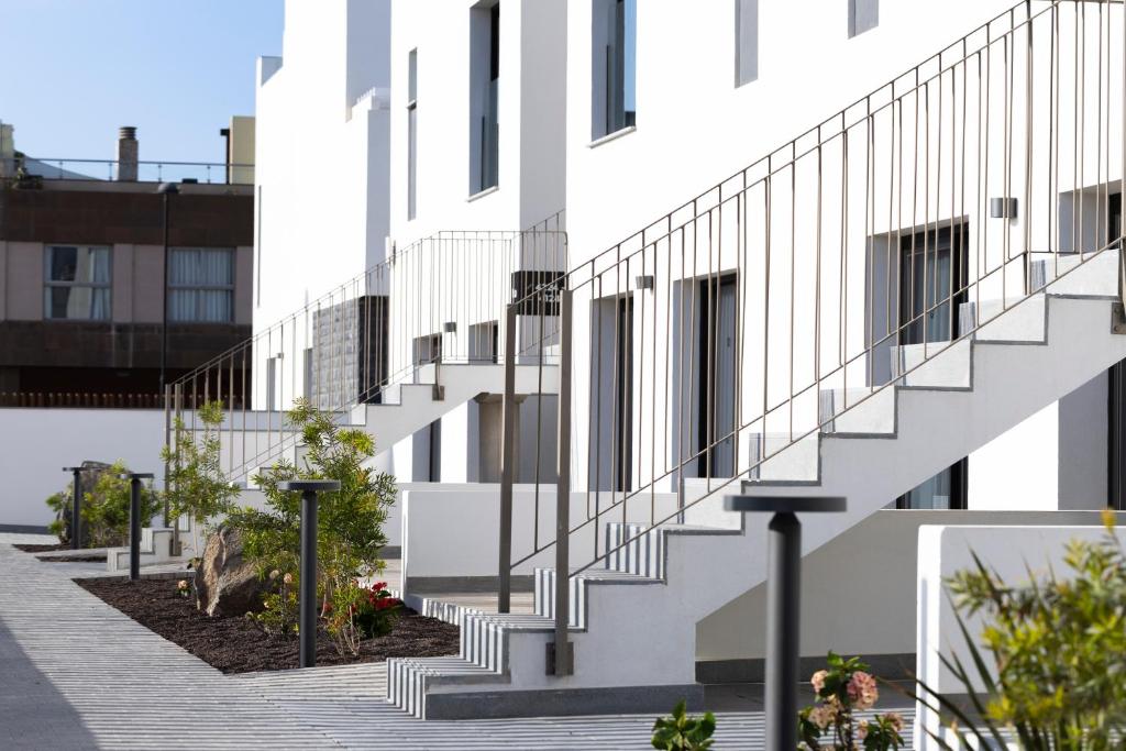 a white building with stairs on the side of it at Esmeralda Cotillo Homes by LIVVO in El Cotillo