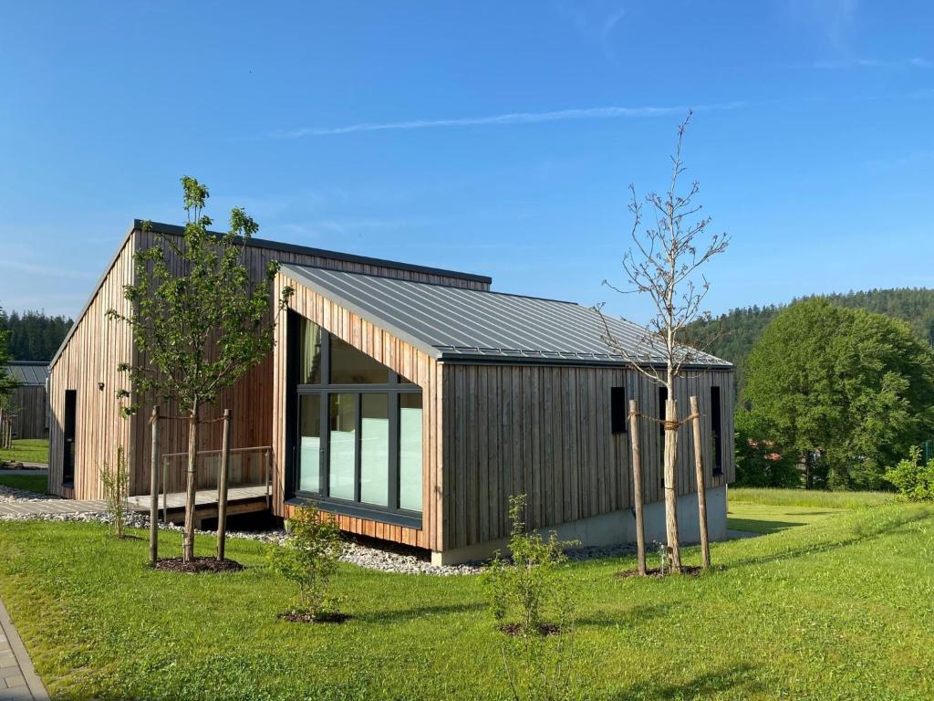 a small wooden house in a field with trees at Waidlerland Chalet "Natur" in Mauth