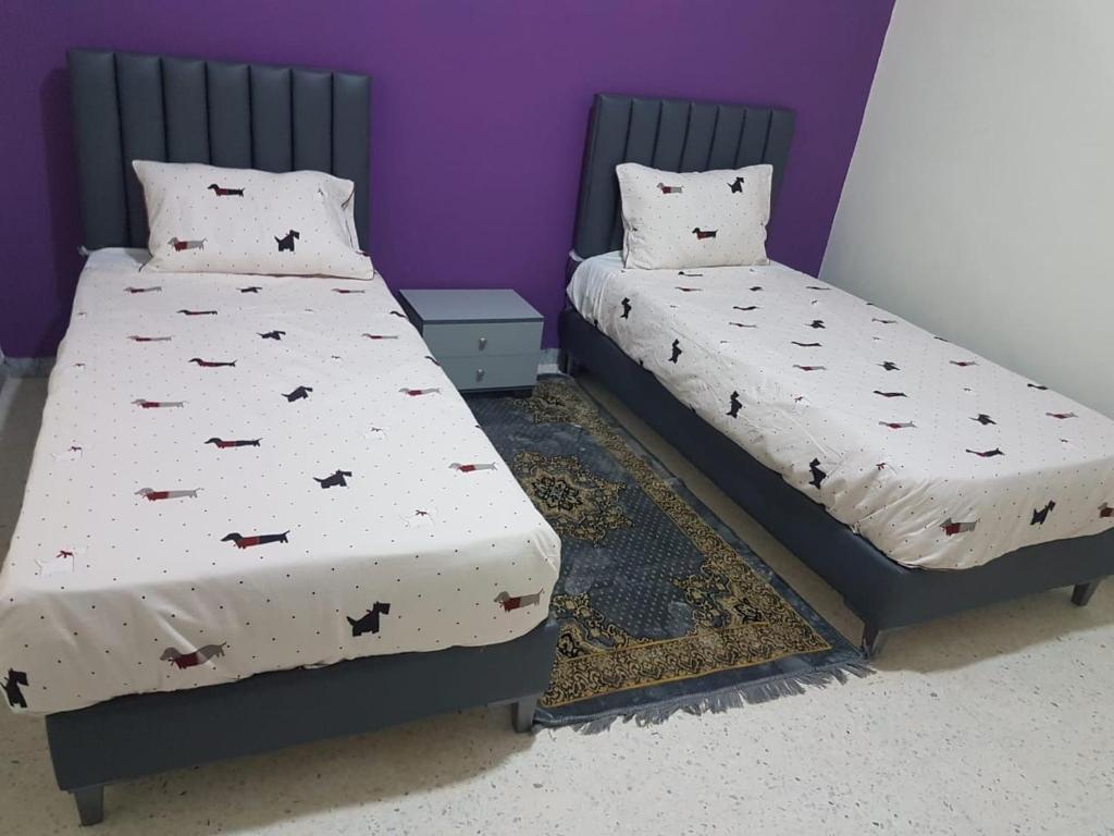 two beds sitting next to each other in a room at Djerba La Douce in Houmt Souk