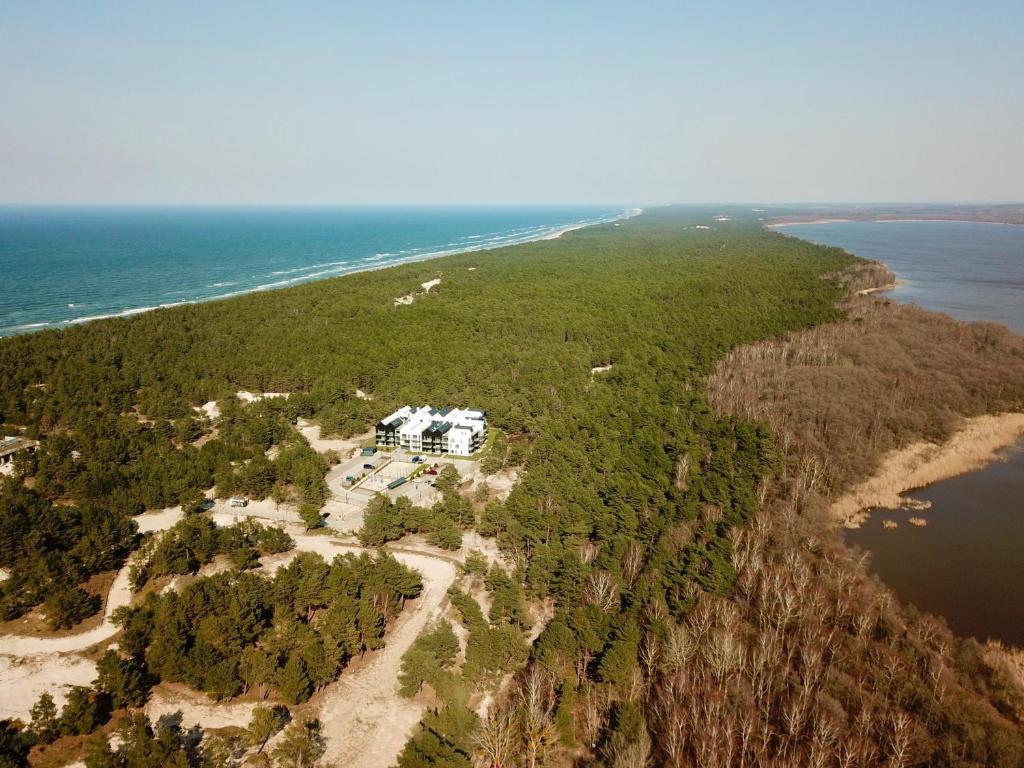 an aerial view of a house on an island in the ocean at Apartamenty In Porto Łeba in Łeba