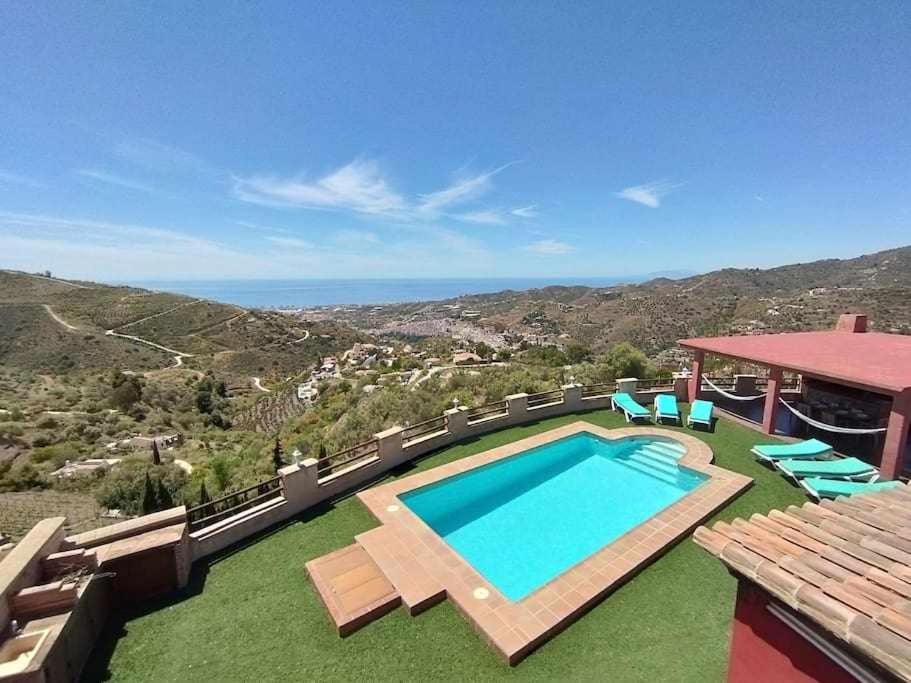 a house with a swimming pool with a view at La Casa Roja Torrox 6 huéspedes y piscina privada in Torrox