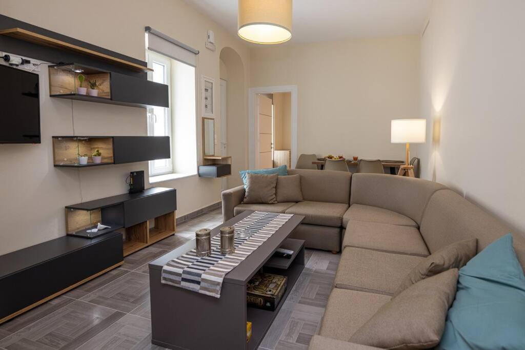 a living room with a couch and a table at MALAMATENIA'S HOUSE in Tinos Town