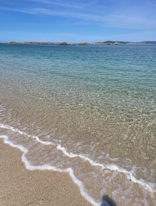 a view of the beach with the water at CASA DA TORRE in O Grove