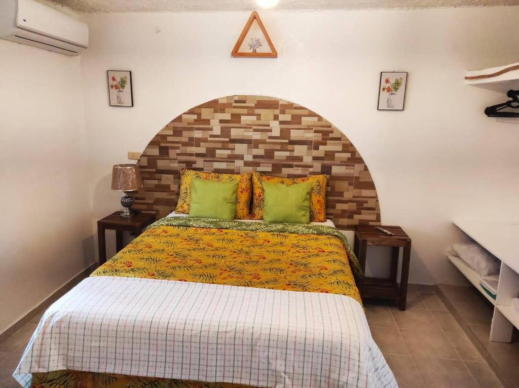 a bedroom with a large bed with a brick wall at Bay View Apt Quiet Area Weeklymonthly Discount in Santa Bárbara de Samaná