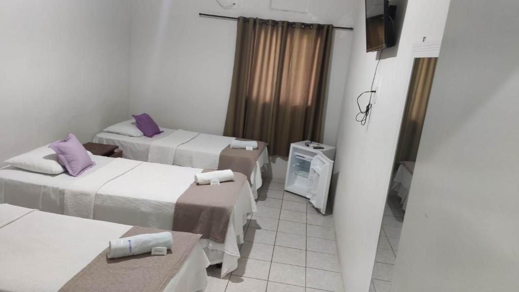 Cama ou camas em um quarto em Pousada Cecosne