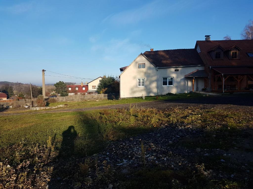 a shadow of a person in front of a house at Chalupa Pod lesem in Telč