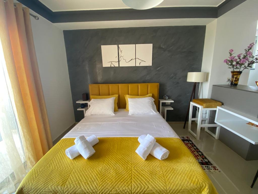 a bedroom with a bed with two towels on it at Best Apartment in Pogradec