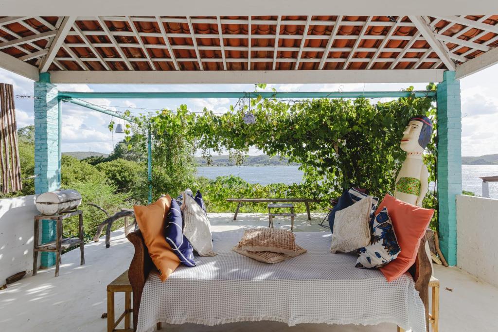 a table with pillows on it on a patio at Casa da Estrelinha - Ilha do Ferro in Gentileza