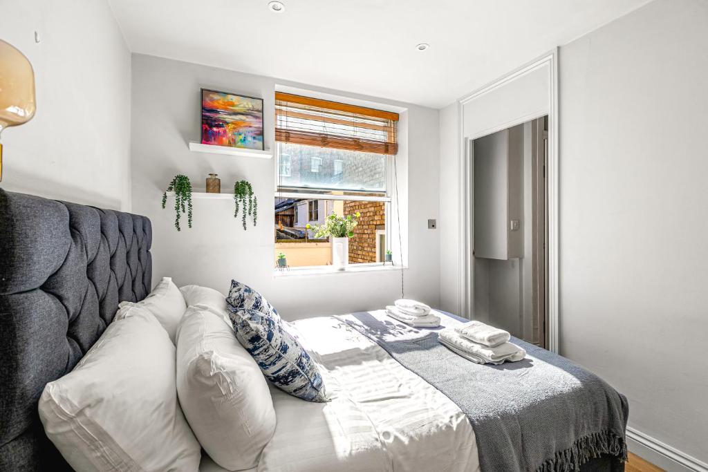 a room with a bed and a couch and a window at Charming Studio Flat next to Holborn station in London