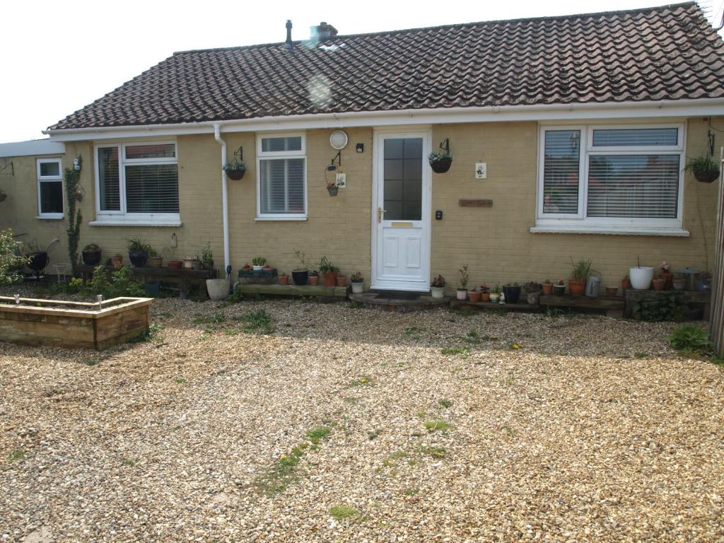 a house with a gravel yard in front of it at peaceholm at cromer in Cromer