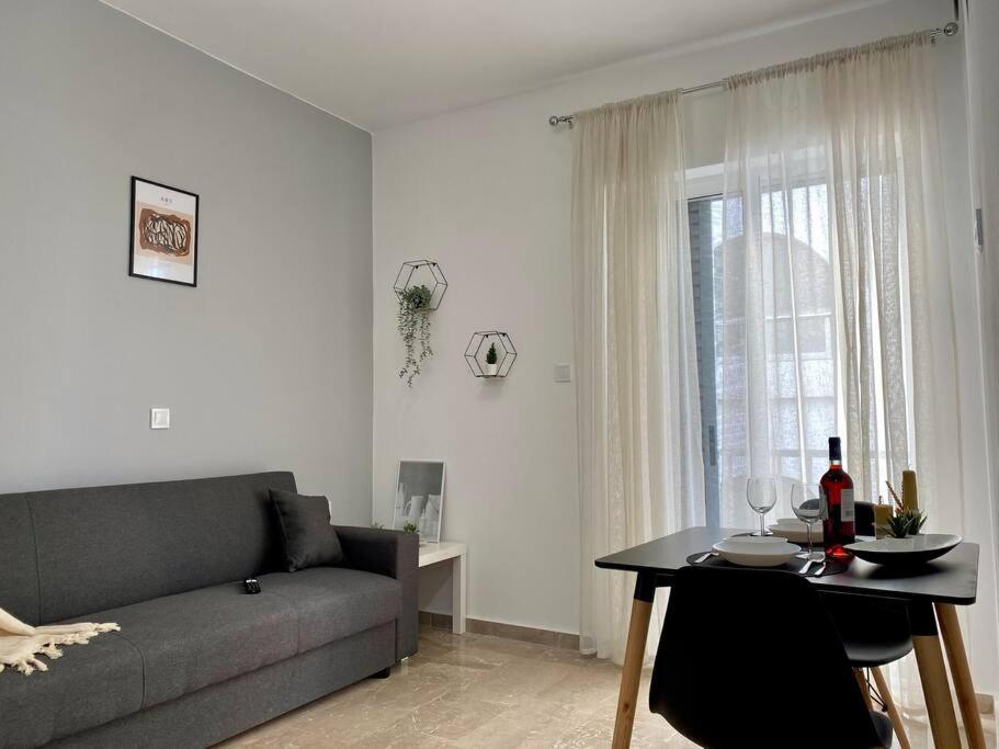 a living room with a couch and a table and a window at Modern Apartment in Kos Town, Walking Distance to the Beach - No 4 in Kos Town
