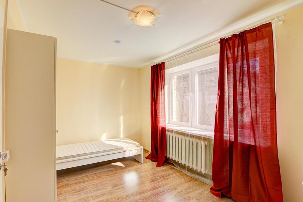 a living room with red curtains and a window at Oginskio st 5 Vilnius Students Home LT in Vilnius