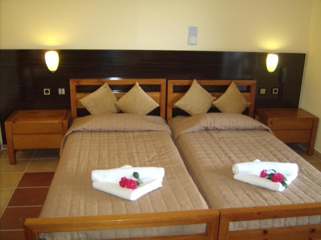 a bedroom with two beds with white towels at Thea Hotel in Possidi