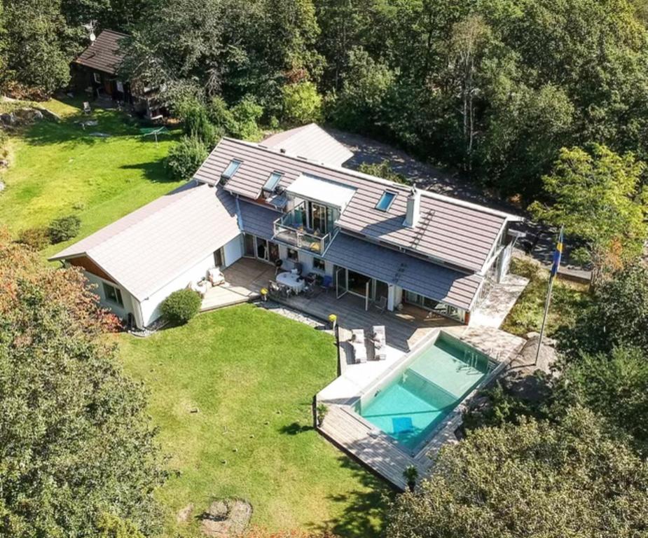 an aerial view of a house with a swimming pool at Spacious and fantastic villa with pool in beautiful Kullavik in Kullavik