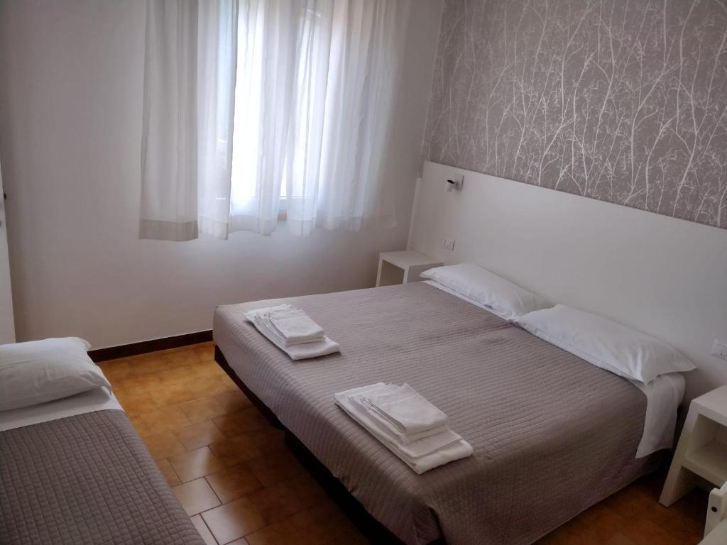 Postel nebo postele na pokoji v ubytování Albergo Conca d'Oro