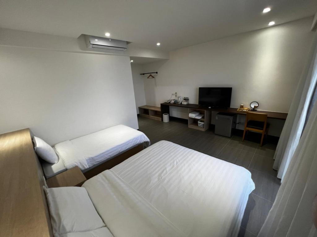 Postel nebo postele na pokoji v ubytování One Roll Stone Homestay
