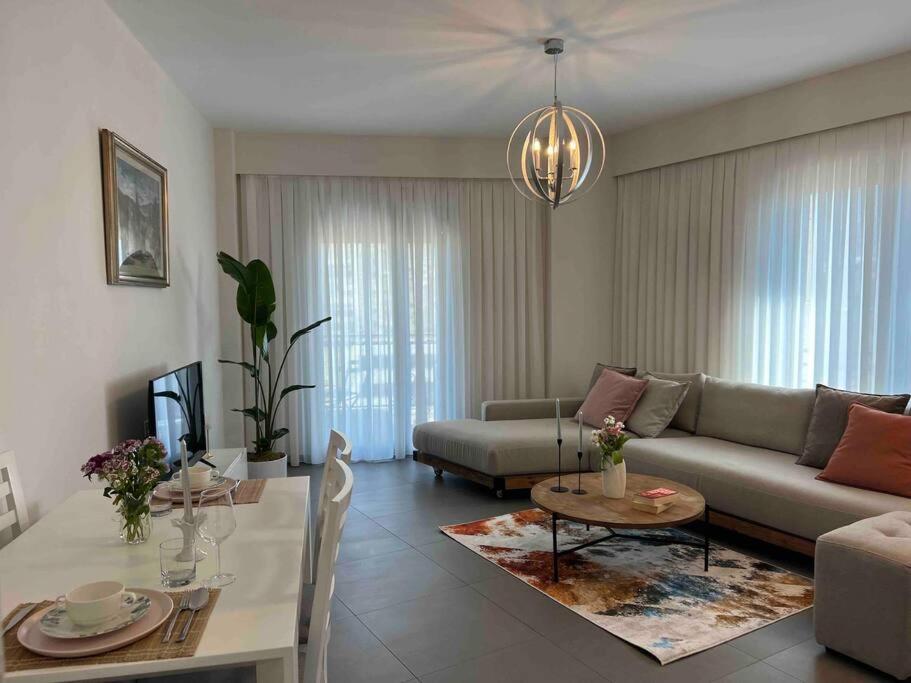 a living room with a couch and a table at Mozart House - Spacious Luxury Apartment - Heart of the City in Tirana