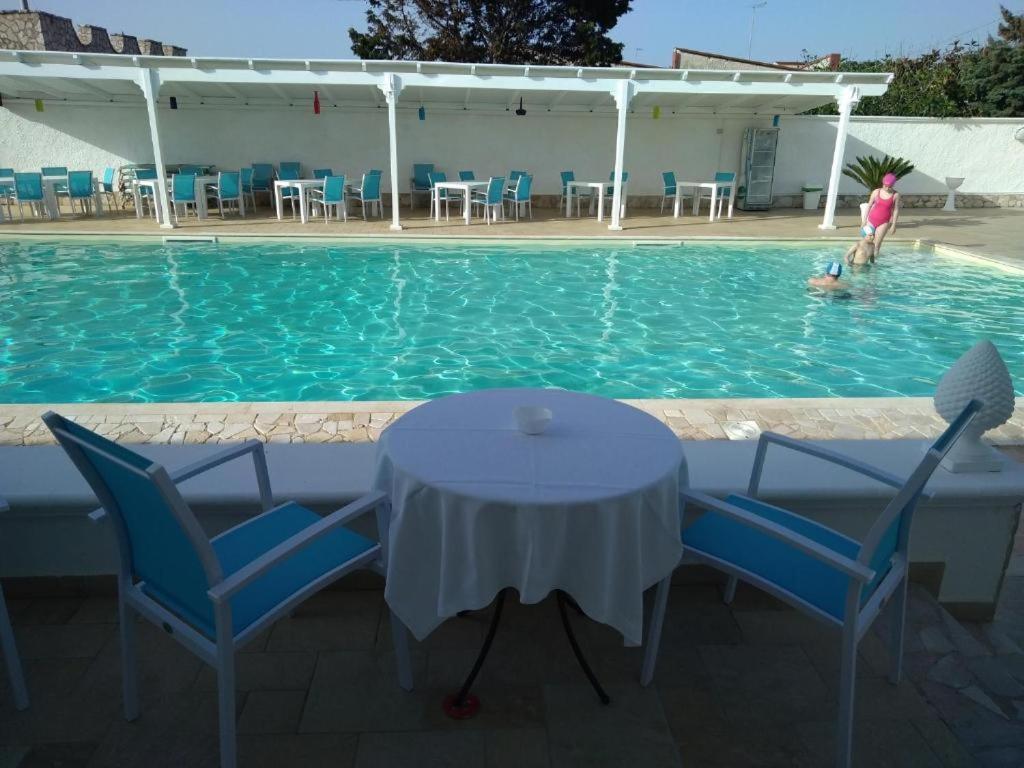 a table and chairs in a swimming pool at Il Galeone B&B in Pulsano