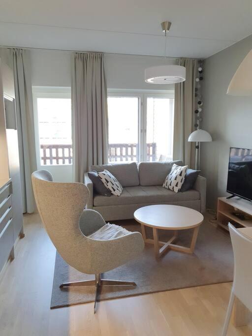 a living room with a couch and a table at Ruka Chalet Front Base in Ruka