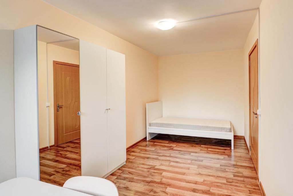 a small room with a bed and a mirror at Smolensko st 13 Vilnius Students Home LT in Vilnius